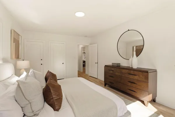 a bed room with a bed and a mirror