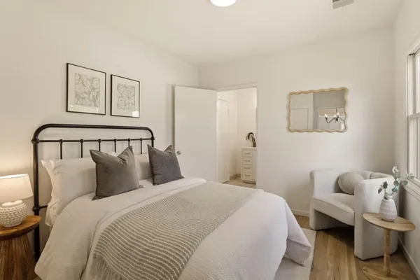 a bedroom with a bed and a painting on the wall