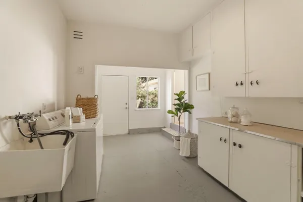 a living room with furniture a window and appliances