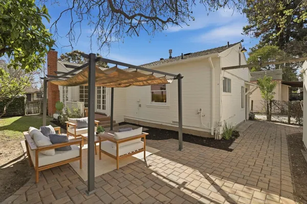 a view of a patio with a table and chairs