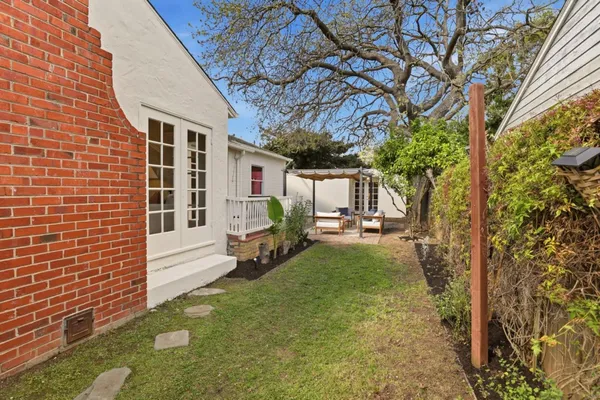 a view of house with backyard and a garden