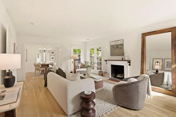 a living room with furniture a fireplace and a table