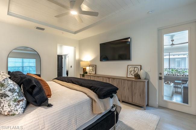 16907 Fairgrove Way, Unit 201 Naples, FL 34110 - Photo 12 of 28 a bedroom with a bed and a flat screen tv