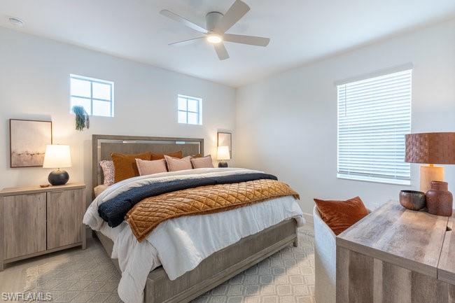 16907 Fairgrove Way, Unit 201 Naples, FL 34110 - Photo 14 of 28 a bedroom with a bed and a window