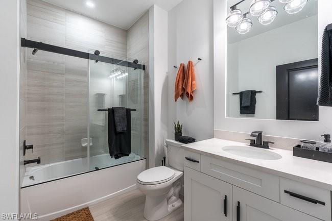 16907 Fairgrove Way, Unit 201 Naples, FL 34110 - Photo 15 of 28 a bathroom with a sink a toilet and shower