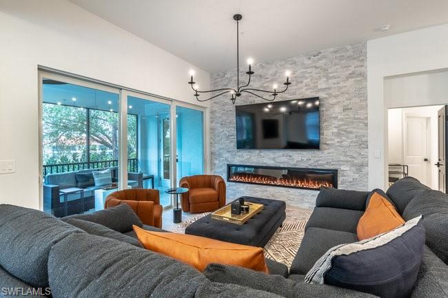 16907 Fairgrove Way, Unit 201 Naples, FL 34110 - Photo 9 of 28 a living room with furniture ceiling fan and a fireplace