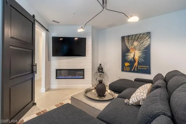 a bedroom with a bed flat screen tv and window