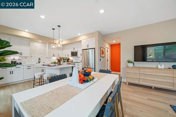 a large kitchen with white cabinets and stainless steel appliances