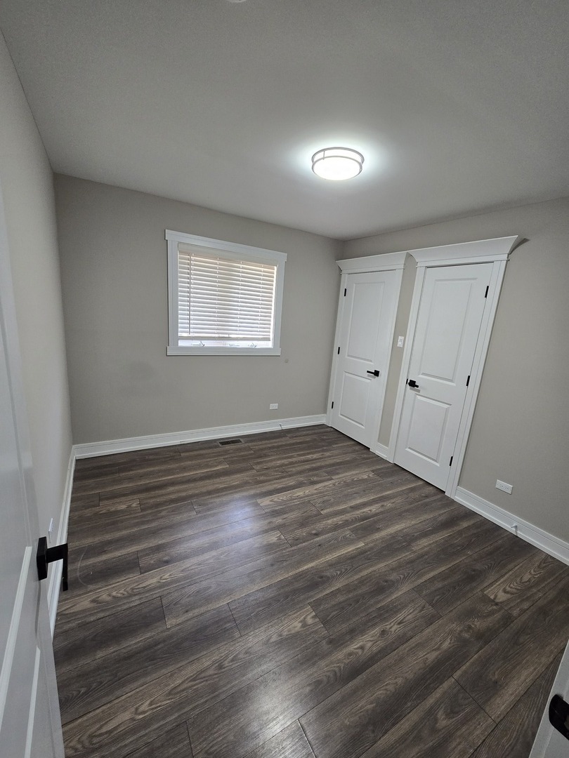 6024 Birmingham Street Chicago Ridge, IL 60415 - Photo 11 of 21 wooden floor in an empty room with a window