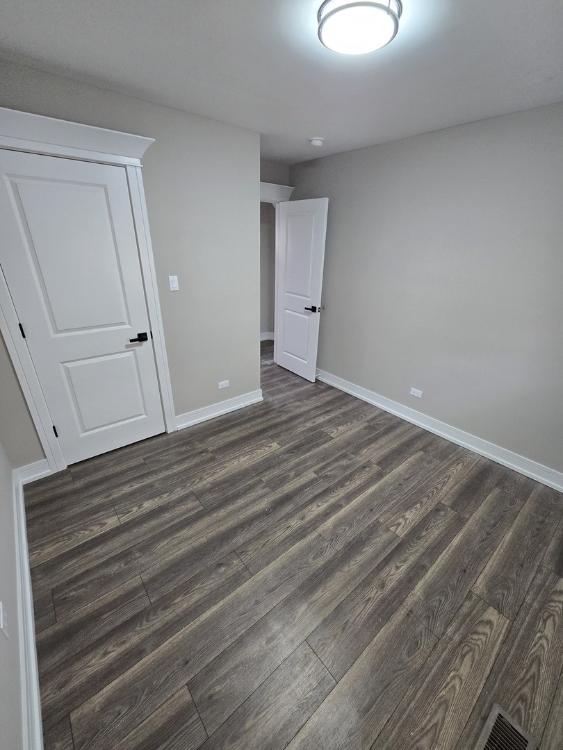 6024 Birmingham Street Chicago Ridge, IL 60415 - Photo 8 of 21 a view of a room with wooden floor and cabinet