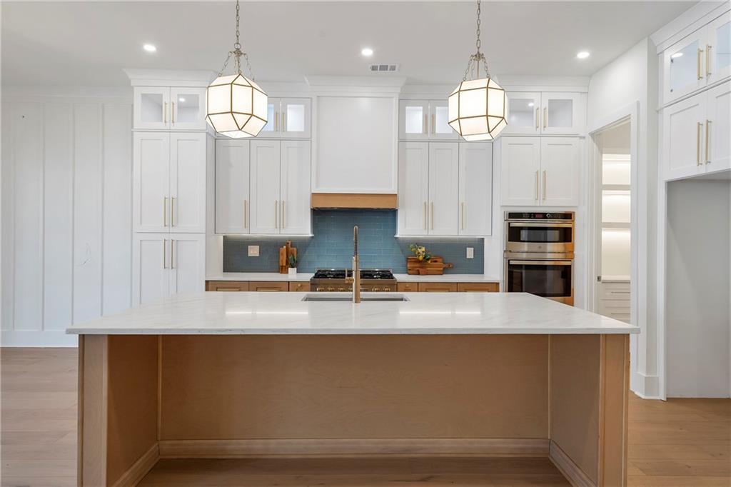 3610 Fleming Drive Cumming, GA 30041 - Photo 11 of 51 a large kitchen with kitchen island white cabinets and stainless steel appliances