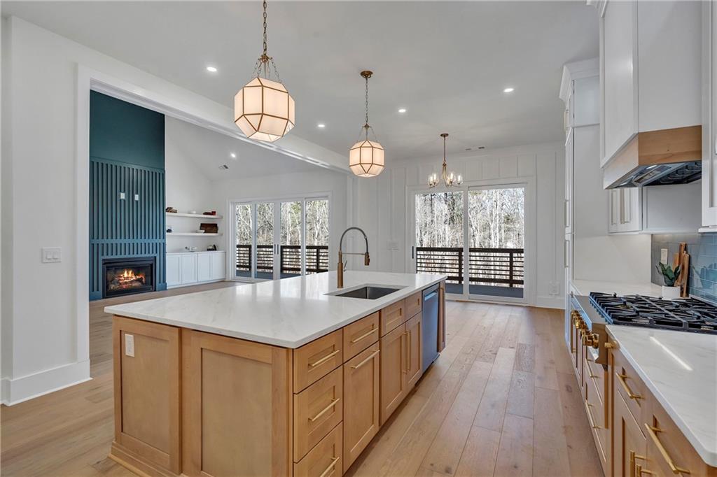 3610 Fleming Drive Cumming, GA 30041 - Photo 13 of 51 a large kitchen with kitchen island a large island in the center a sink a window and stainless steel appliances