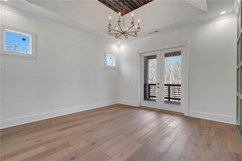 3610 Fleming Drive Cumming, GA 30041 - Photo 19 of 51 a view of an empty room with wooden floor and a ceiling fan