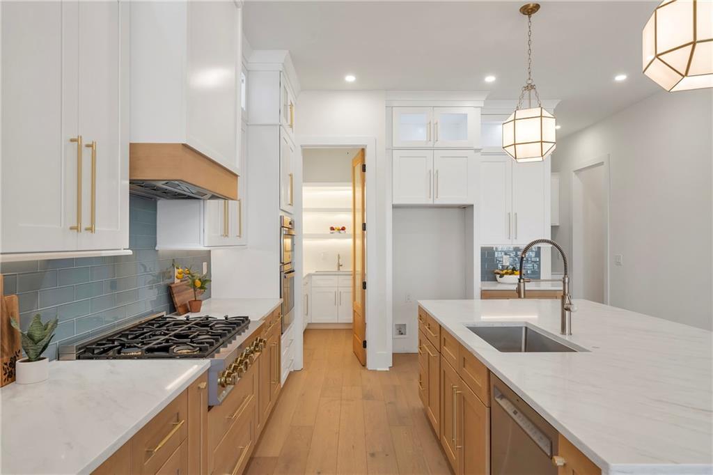 3610 Fleming Drive Cumming, GA 30041 - Photo 3 of 51 a kitchen with kitchen island a sink stainless steel appliances and cabinets