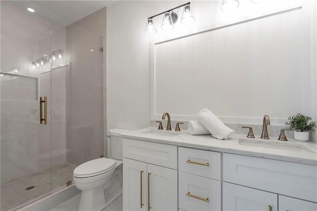 3610 Fleming Drive Cumming, GA 30041 - Photo 35 of 51 a bathroom with a granite countertop sink a toilet and shower