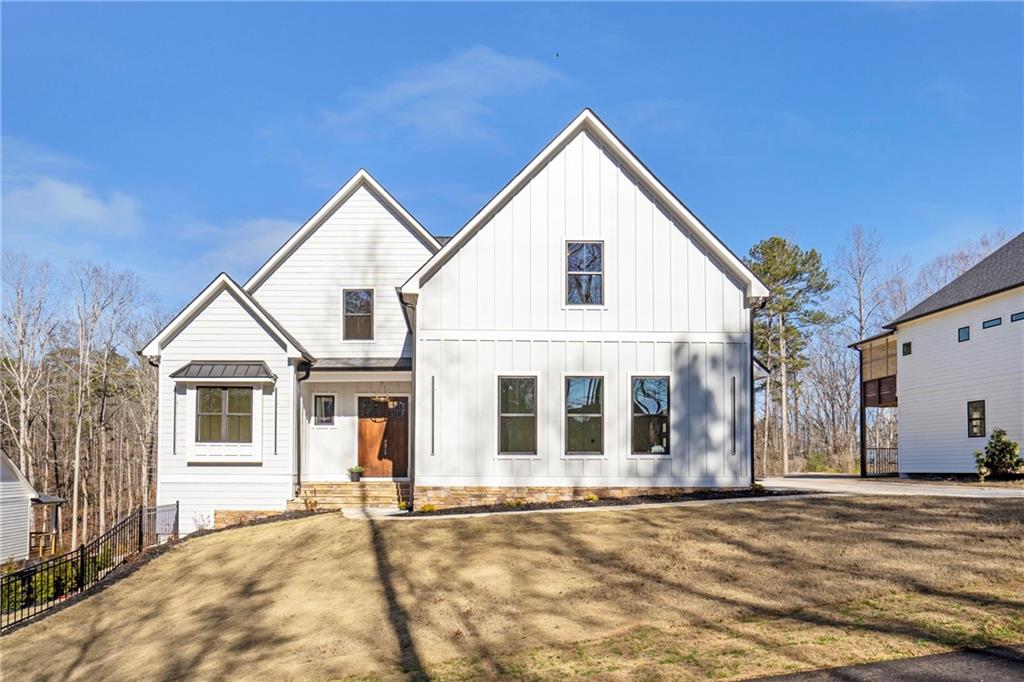 3610 Fleming Drive Cumming, GA 30041 - Photo 47 of 51 a view of a white house with a yard next to a road