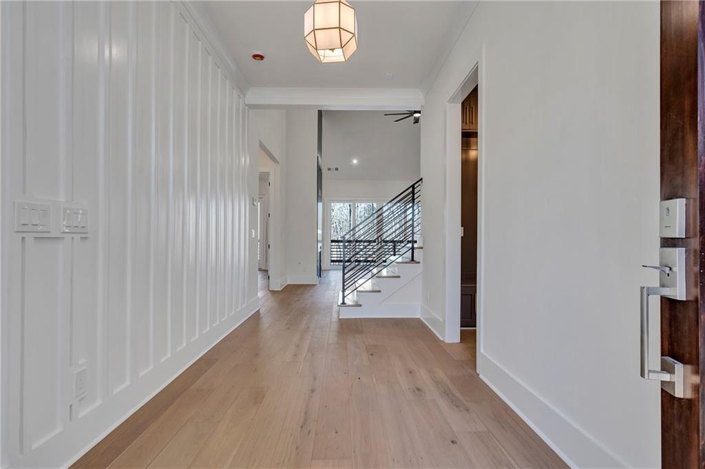 3610 Fleming Drive Cumming, GA 30041 - Photo 5 of 51 a view of a hallway with wooden floor and a chandelier