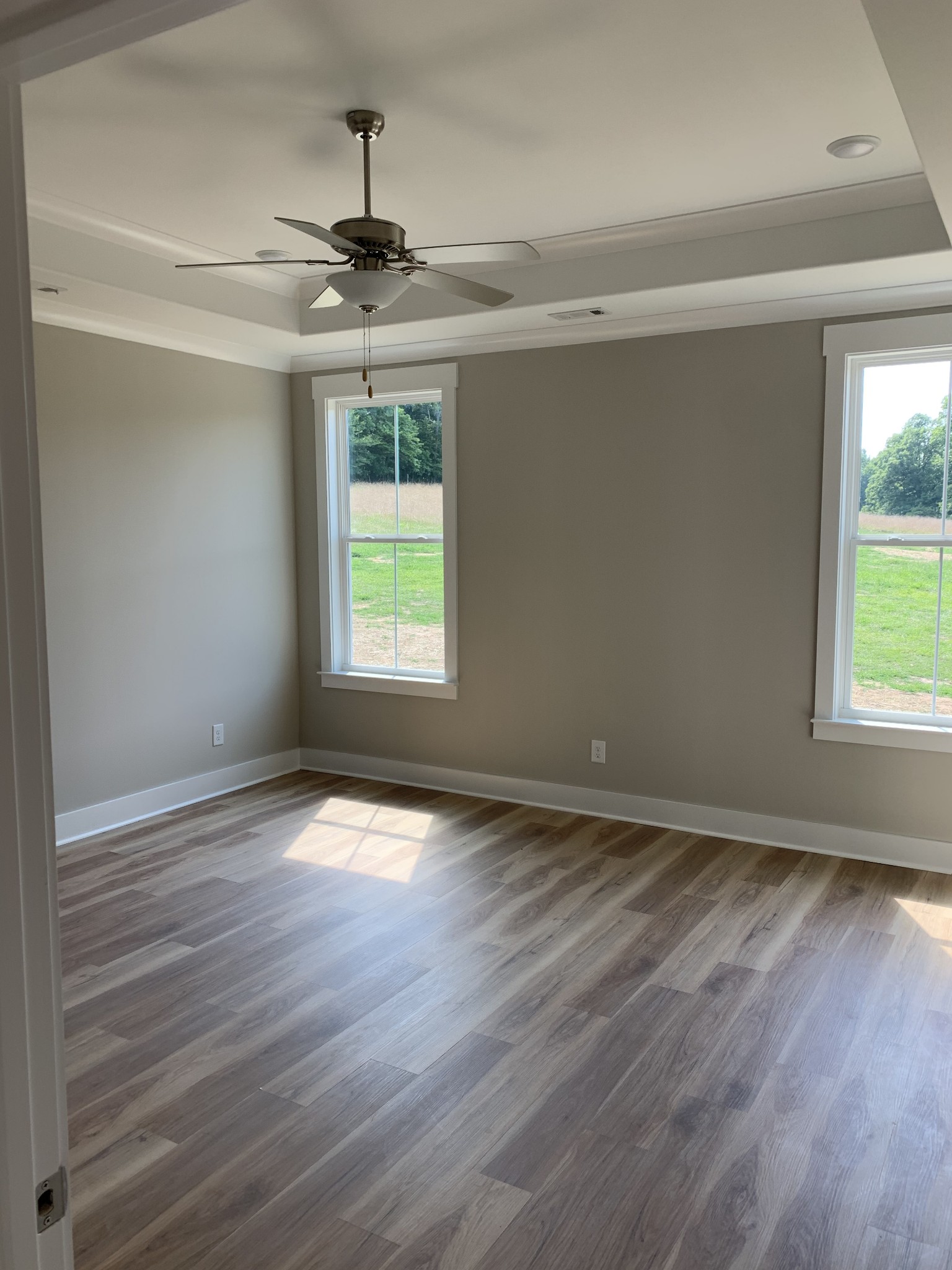 1810 Old Gallatin Road Portland, TN 37148 - Photo 45 of 52 an empty room with wooden floor chandelier and windows