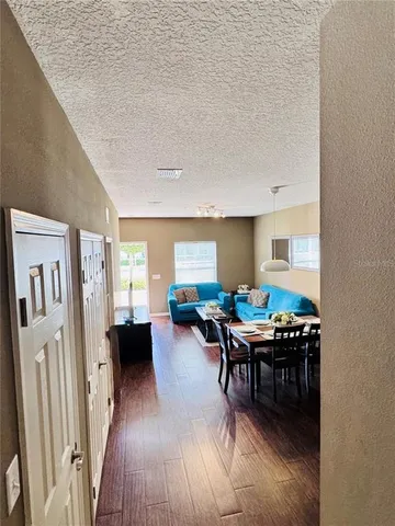 a dining room with furniture and wooden floor