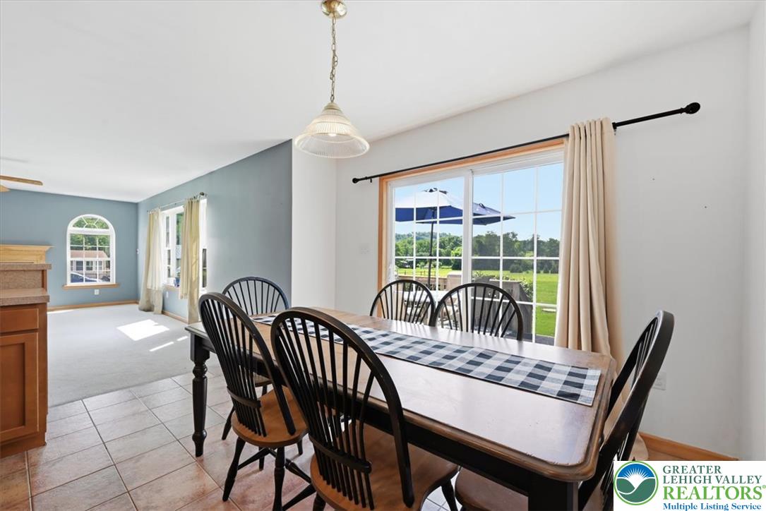 66 Labar Road Bangor, PA 18013 - Photo 14 of 56 A welcoming dining area features a sliding glass door offering verdant outdoor views.
