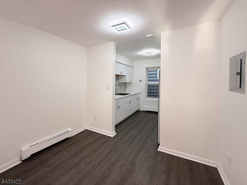 19 Van Rensselear Street, Unit 4 Belleville, NJ 07109 - Photo 6 of 10 wooden floor in an empty room with a kitchen