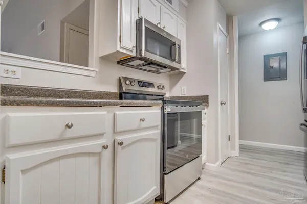 a kitchen with granite countertop a stove oven and sink