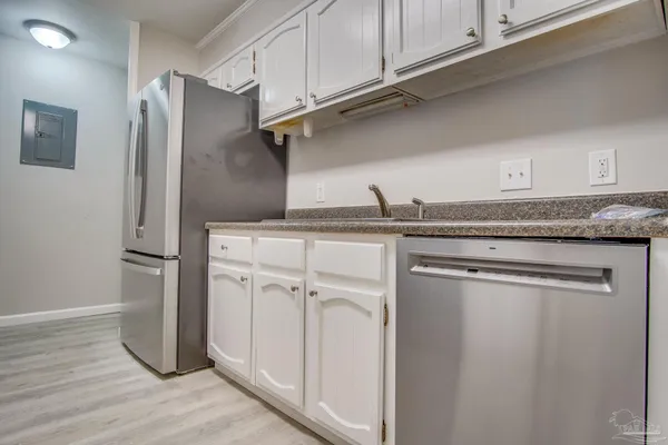 a kitchen with a refrigerator and cabinets