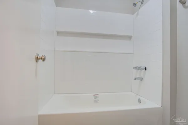 a bathroom with a granite countertop sink and a bathtub
