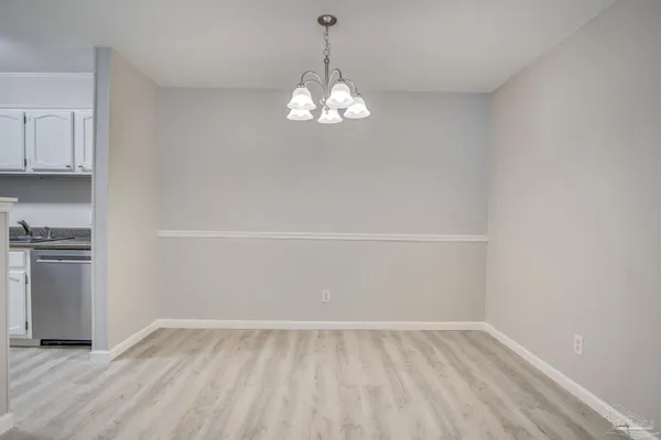 a view of an empty room with a kitchen