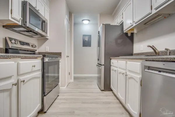 a kitchen with stainless steel appliances granite countertop a refrigerator and a stove