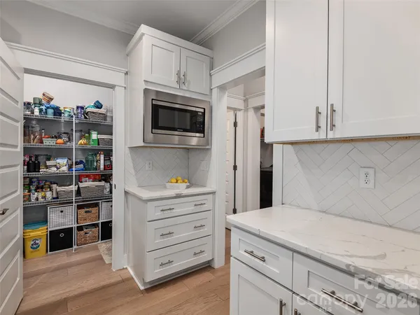 a kitchen with stainless steel appliances a microwave and cabinets