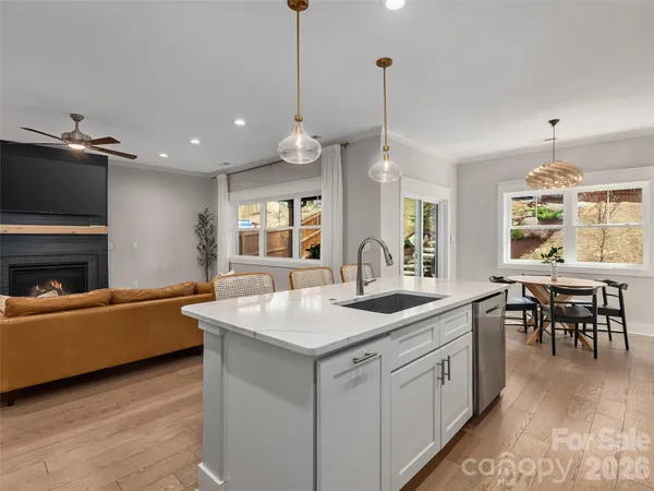 a kitchen with granite countertop a sink a counter space appliances and living room