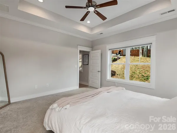 a bedroom with a large bed and a window