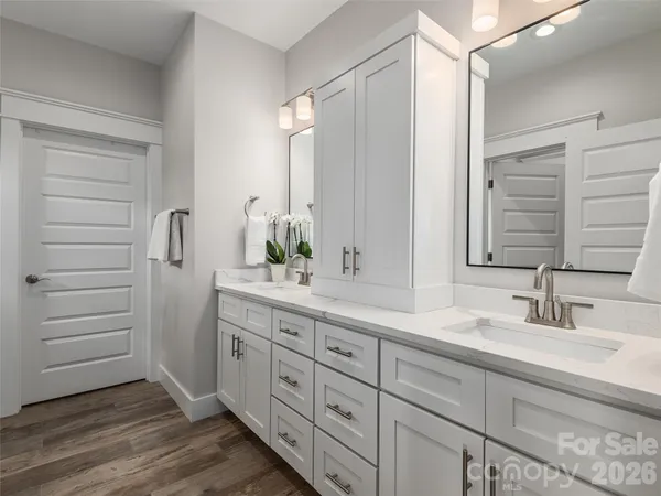 a bathroom with a double vanity sink and mirror