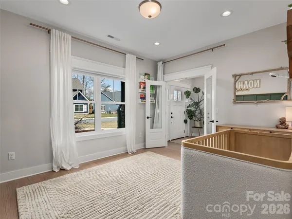 a living room with stainless steel appliances granite countertop furniture a couch and a window