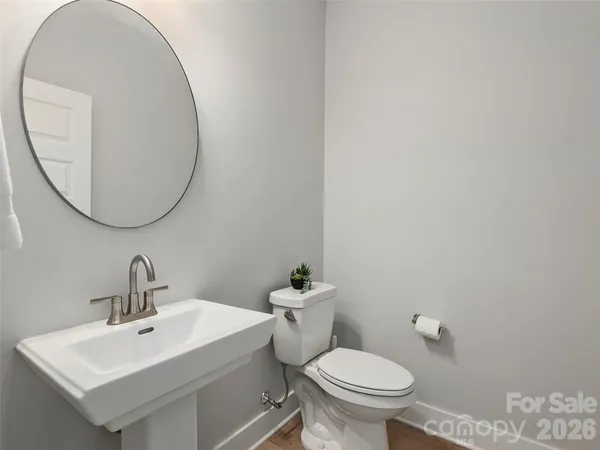 a bathroom with a sink a mirror and a toilet