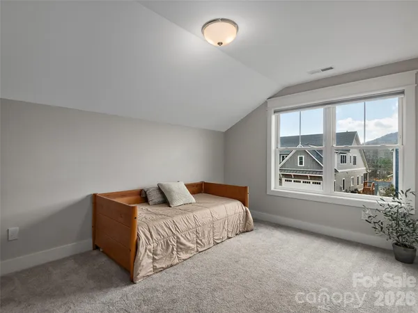 a bedroom with a bed and a large window