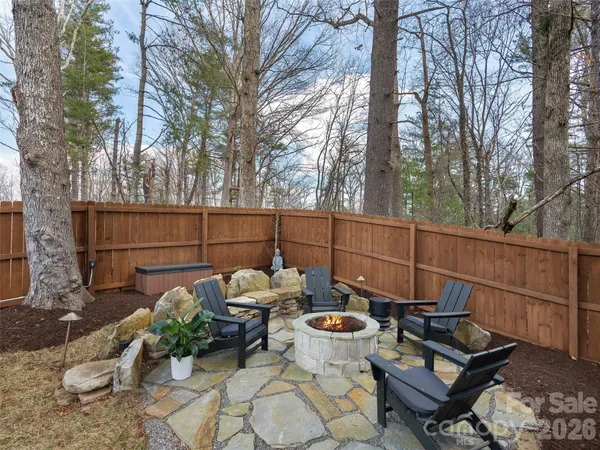 a view of a backyard with furniture and a fire pit
