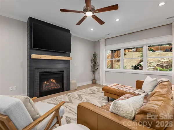 a living room with furniture fireplace and flat screen tv