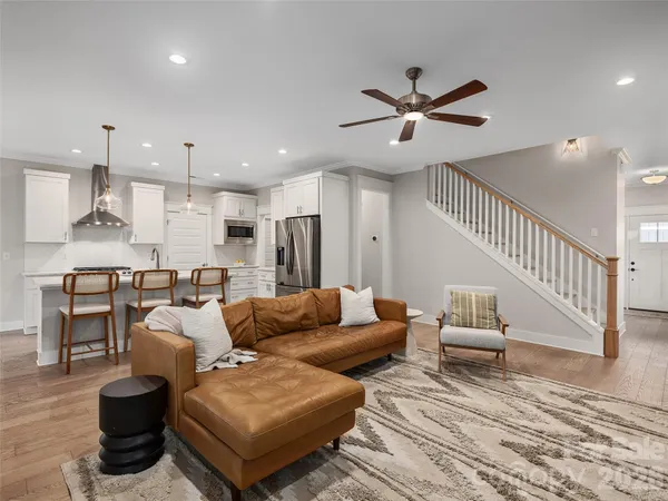 a living room with furniture and kitchen view