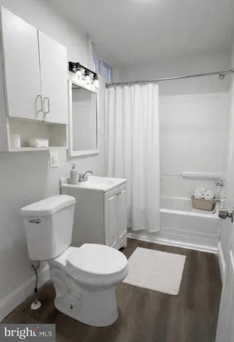 a bathroom with a sink toilet a mirror and shower