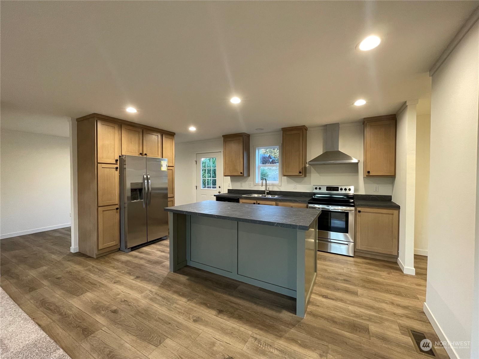 230 Bunker Creek Road Chehalis, WA 98532 - Photo 3 of 19 a kitchen with stainless steel appliances kitchen island granite countertop a refrigerator and a stove top oven