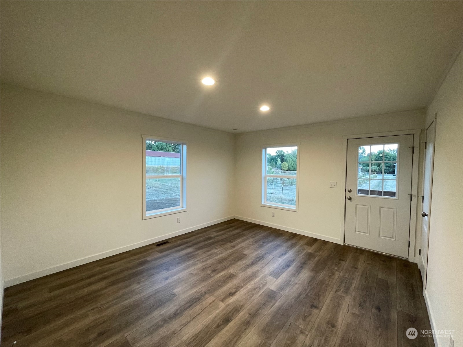 230 Bunker Creek Road Chehalis, WA 98532 - Photo 6 of 19 an empty room with wooden floor and windows