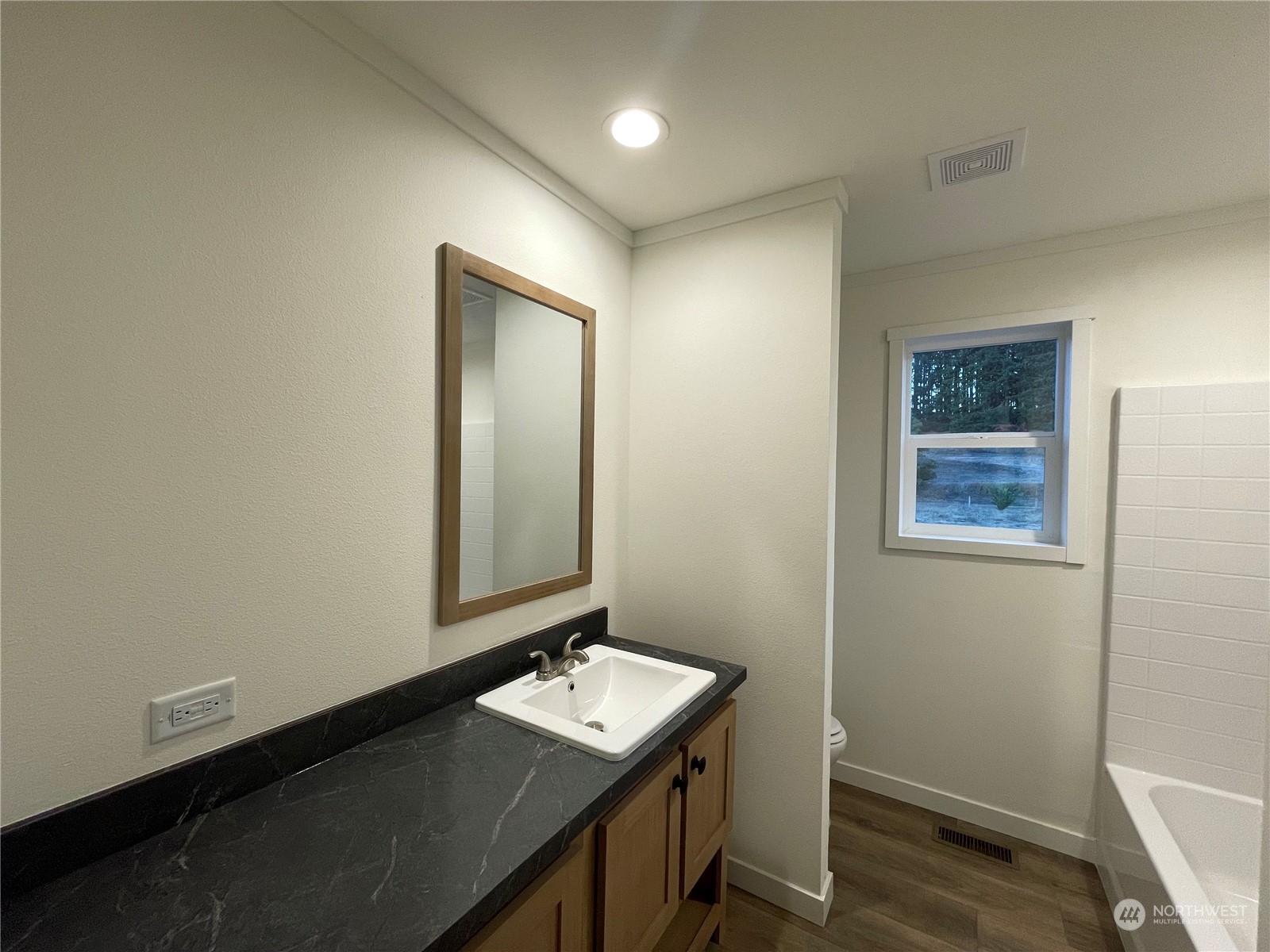 230 Bunker Creek Road Chehalis, WA 98532 - Photo 8 of 19 a view of bathroom with a sink a mirror and wooden floor