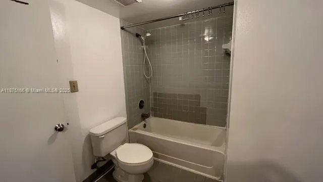 a bathroom with a shower a toilet and a bathtub
