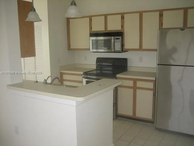 a kitchen with a sink and refrigerator