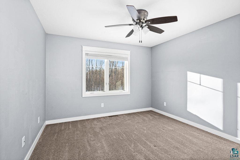 3879 Okerstrom Road Hermantown, MN 55811 - Photo 26 of 32 Carpeted empty room featuring baseboards and a ceiling fan