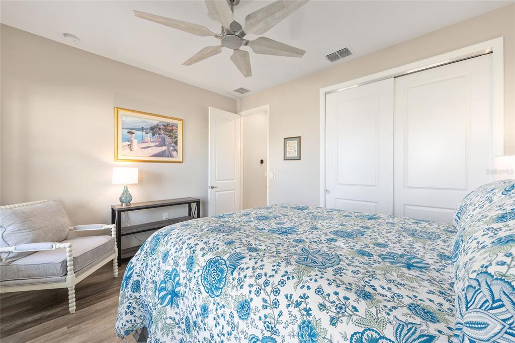 10390 Southwest 99th Street Ocala, FL 34481 - Photo 13 of 48 a bedroom with a bed and a chandelier