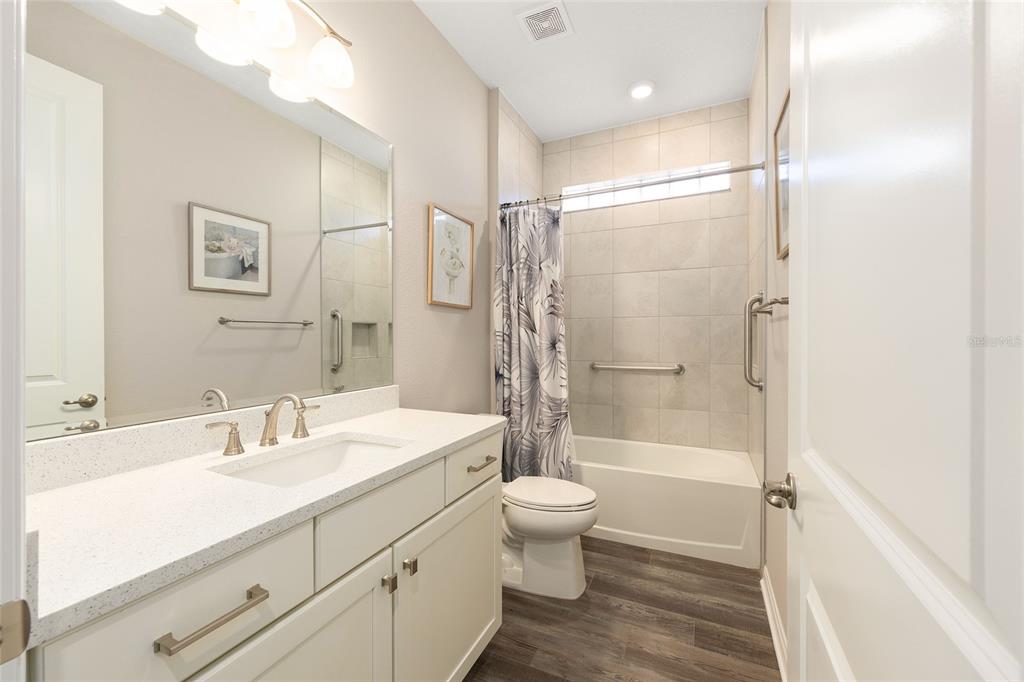 10390 Southwest 99th Street Ocala, FL 34481 - Photo 14 of 48 a bathroom with a shower sink vanity mirror and toilet