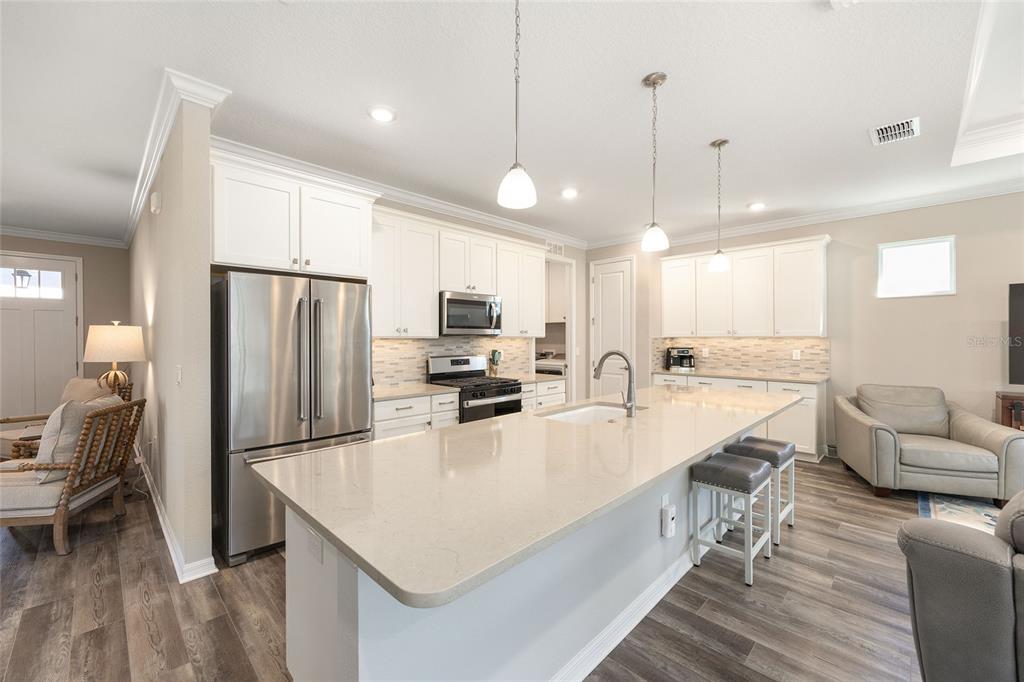 10390 Southwest 99th Street Ocala, FL 34481 - Photo 21 of 48 a kitchen with stainless steel appliances granite countertop a sink refrigerator and cabinets